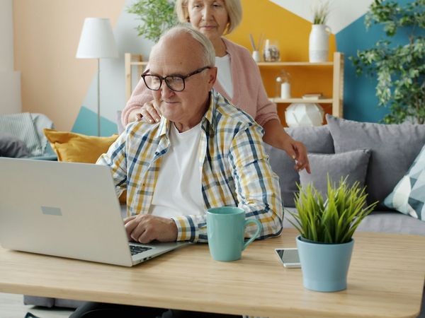 A homeowner researching property values on a laptop at home