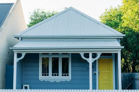 A weatherboard cottage with a front garden in New South Wales