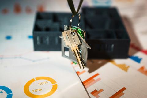 House keys and model houses on printed property papers