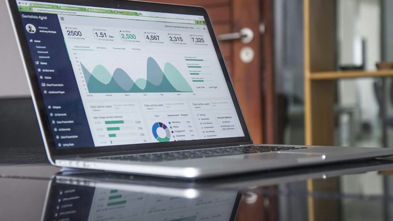 A laptop showing charts and figures