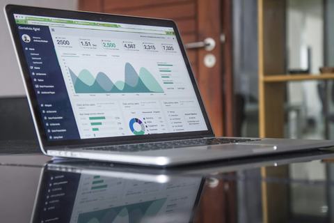 A laptop showing charts and figures