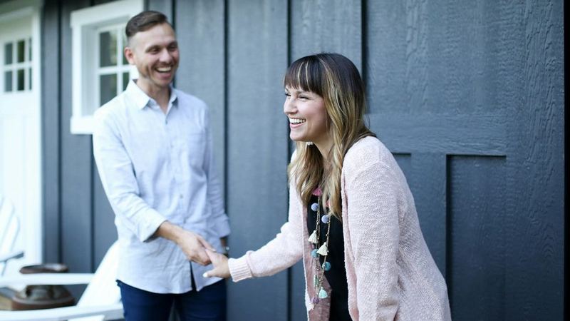 An agent greeting a homeowner at the front door